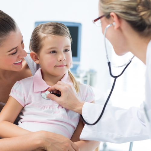 Mother with girl being examined by female pediatrician in clinic Mother with girl being examined by female pediatrician in clinic